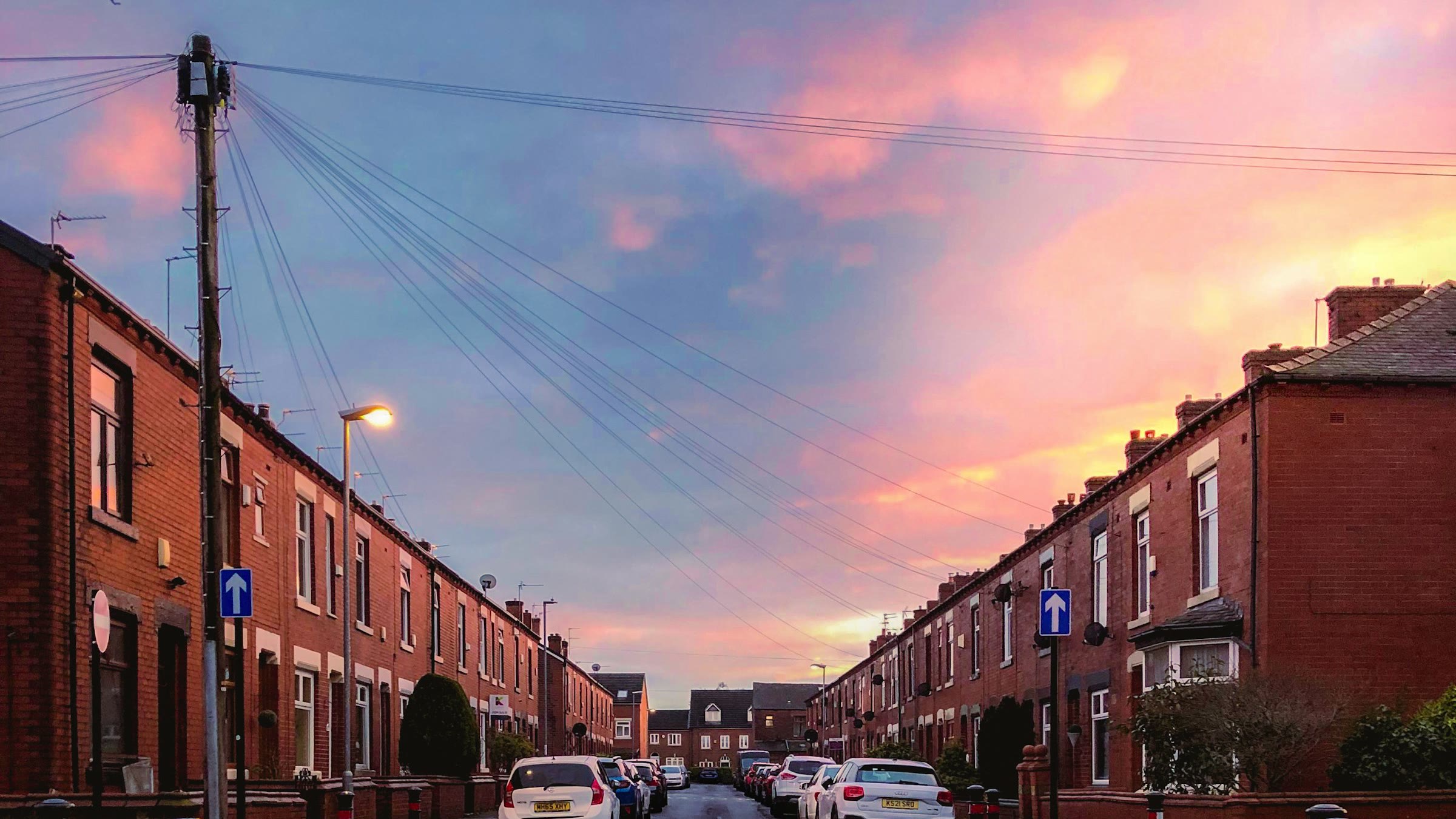 A street of red brick terraced houses at sunrise